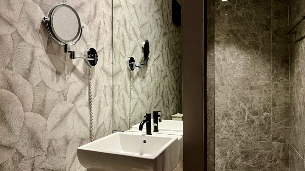 Our premium treatment rooms feature vanities, makeup mirrors, hair dryers, and tiled walk-in showers.